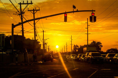 Traffic on road at sunset