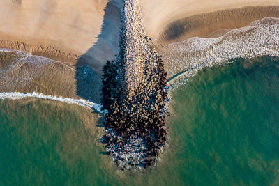 Drone shot of a wave breaker