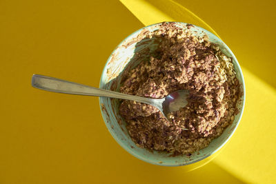 High angle view of breakfast served in bowl on yellow table
