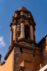 Low angle view of building against clear blue sky