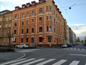 View of city street and buildings against sky