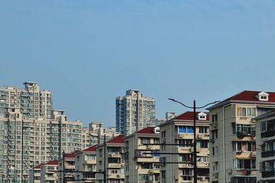 Low angle view of buildings against blue sky