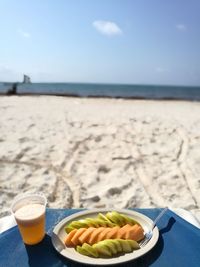 Food and drink on towel at beach