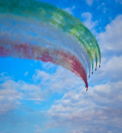 Low angle view of airplane flying against sky