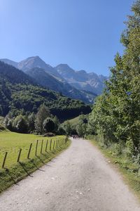 Road amidst mountains against clear sky