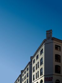 Low angle view of building against clear blue sky