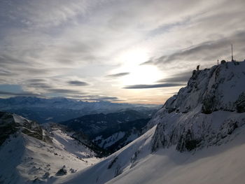 Scenic view of snowcapped mountains against sky during sunset