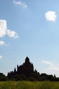 Built structure on landscape against sky