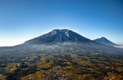 Scenic view of mountains against clear blue sky