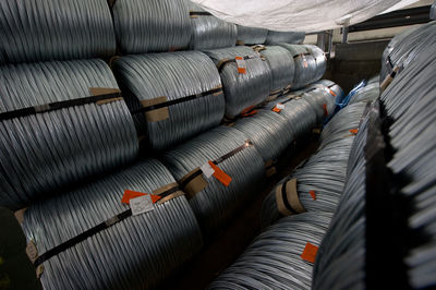 High angle view of metallic rolled up wires at steel plant