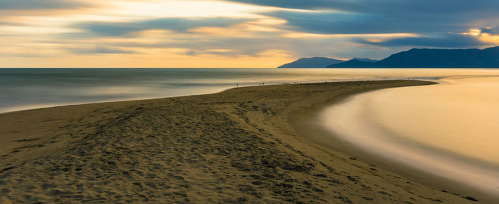 Scenic view of beach against sky during sunset