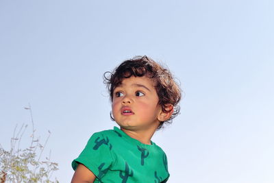 Portrait of cute boy against clear sky