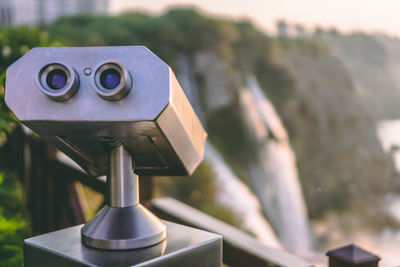 Close-up of coin-operated binoculars against blurred background