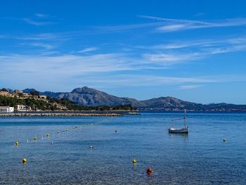 Scenic view of bay against blue sky