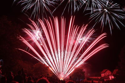 Low angle view of firework display at night