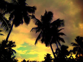 Low angle view of silhouette palm trees against sky during sunset