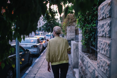 Rear view of woman walking on street