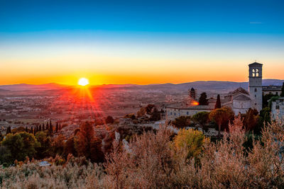 Scenic view of buildings against sky during sunset