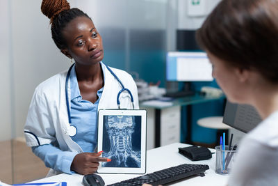 Doctor talking with patient in clinic