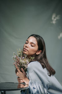 Young woman holding flower bouquet