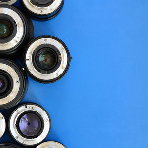 Directly above shot of various lenses on blue background