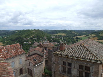 High angle view of houses against cloudy sky