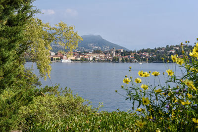 Scenic view of sea by buildings against sky