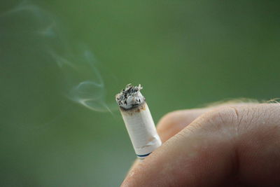 Close-up of man holding cigarette