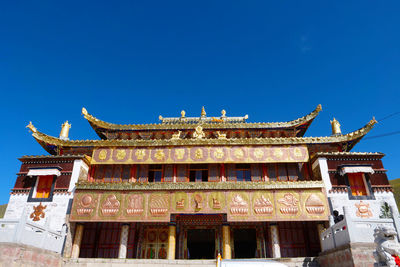 Low angle view of building against blue sky