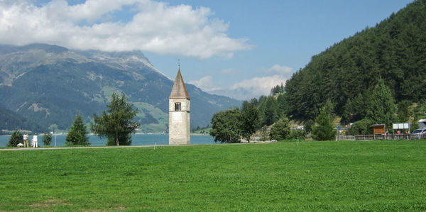 The bell tower of the former church of curon venosta in lake resia, south tyrol, italy.