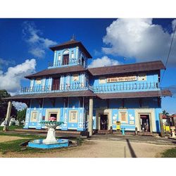 Built structure against blue sky and clouds