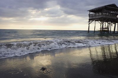 Scenic view of beach against sky during sunset