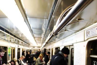 People standing in train at railroad station