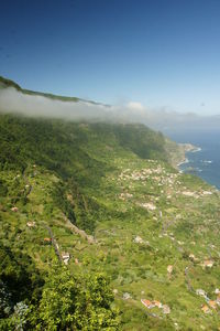 Scenic view of landscape and sea against sky