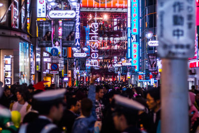 Crowd at illuminated city at night