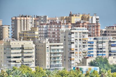 Buildings in city against clear sky