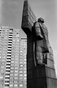 Low angle view of statue against building in city