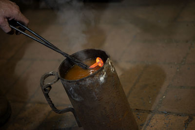 Cropped hand of blacksmith in workshop