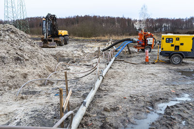 Wellpoint installation to get rid of high groundwater, visible metal pipes and a large water pump.