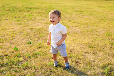 Portrait of smiling boy standing on grass