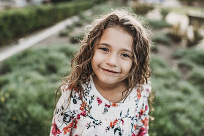 Close up portrait of young school-aged confident girl smiling at