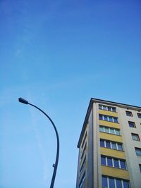 Low angle view of buildings against clear blue sky