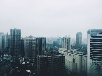 High angle view of buildings in city against sky