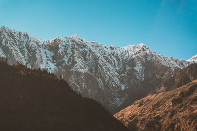 Scenic view of snowcapped mountains against clear sky