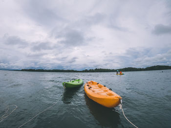 Boat floating on sea against sky