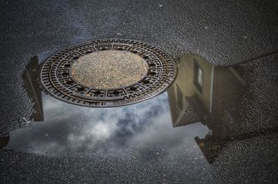 High angle view of manhole on tiled floor