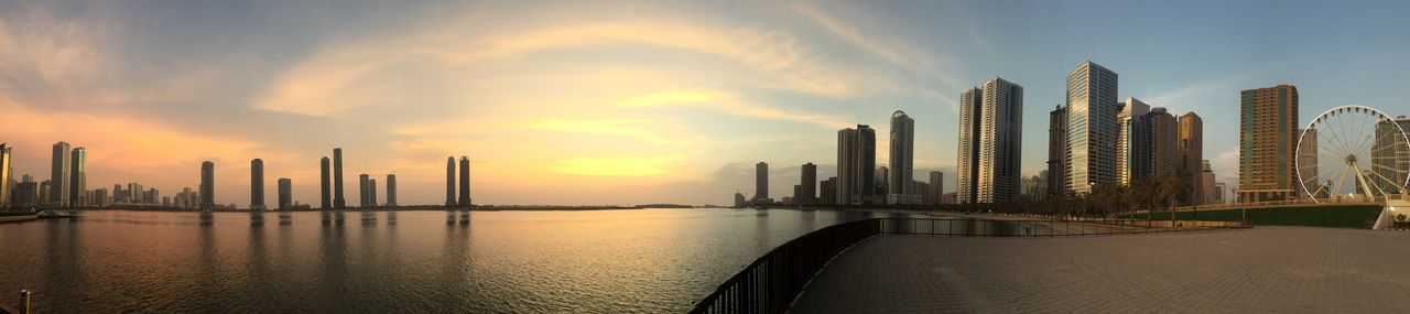 architecture, built structure, sunset, skyscraper, sky, building exterior, water, city, cloud - sky, waterfront, outdoors, urban skyline, travel destinations, no people, cityscape, modern, beauty in nature, nature, day