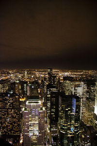 Aerial view of city lit up at night