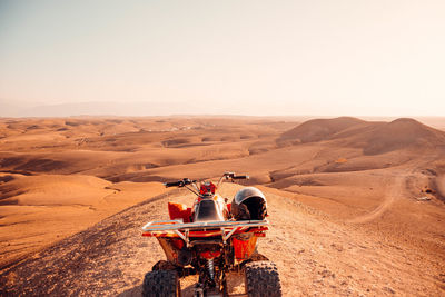 Horse cart on desert against sky