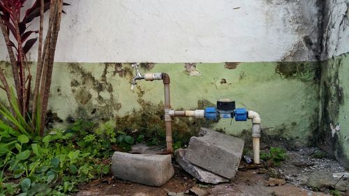 Old-fashioned tap against wall in back yard